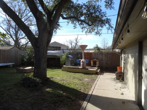 Fenced in backyard with sidewalk to Guest house entry door