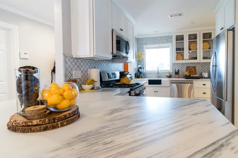 Gourmet kitchen, marble counter/backsplashes, large farm sink, and more!