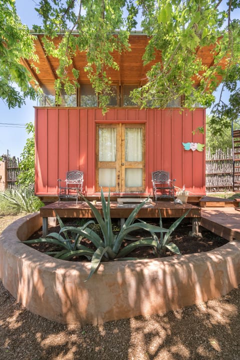 View of your Cute Eco-cabin and native agave plants among your deck loungers...
