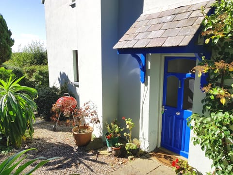 The attractive front door to Granary Cottage with BBQ nearby