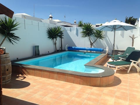 A heated pool, sun loungers