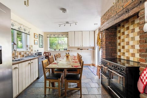The farmhouse kitchen has a ten seater dining table, range cooker and American fridge freezer. The separate utility room has ample hanging space for outdoor coats, washing machine, tumble dryer and drinks fridge plus an adjoining shower room/loo.