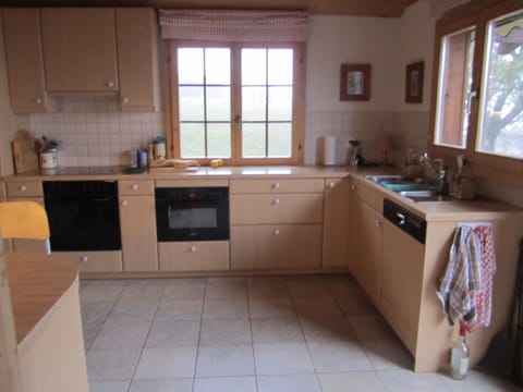 Fully equipped kitchen with door opening onto garden and amazing views