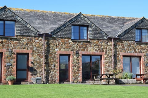 Front of cottage faces large lawned area