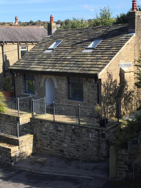 Another view of cottage front showing small parking area to front