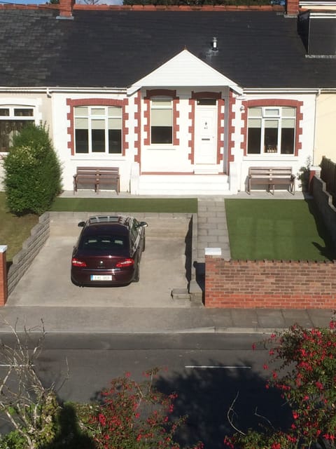 Front of house with 2 car off road parking.