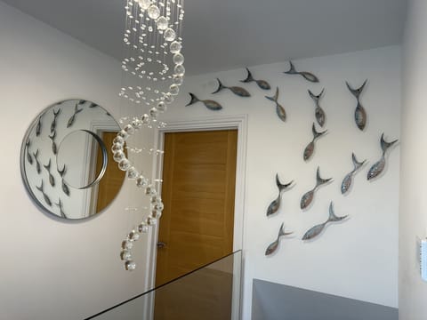 Jo Downs glass fish over stairwell 