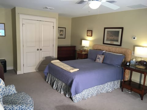 Master bedroom has queen-size bed and seating area