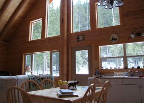 View of living/dining room windows which look out onto an acre of wooded land