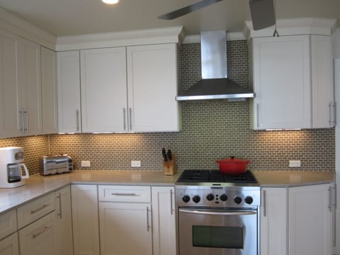Kitchen has Modern Stainless Steel Appliances & Solid Surface Counter Tops