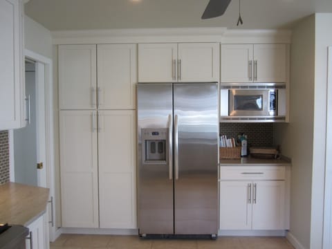 Kitchen has Modern Stainless Steel Appliances & Solid Surface Counter Tops