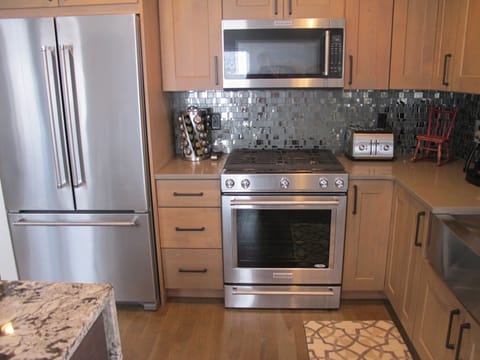 dual fuel range w/ warming drawer, and counter depth fridge with ice maker