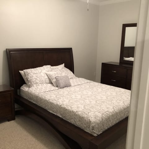 Queen bed in basement, with full bath