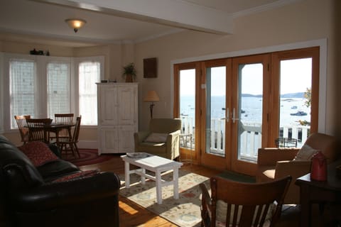 French doors open to wrap-around deck with expansive views of harbor.