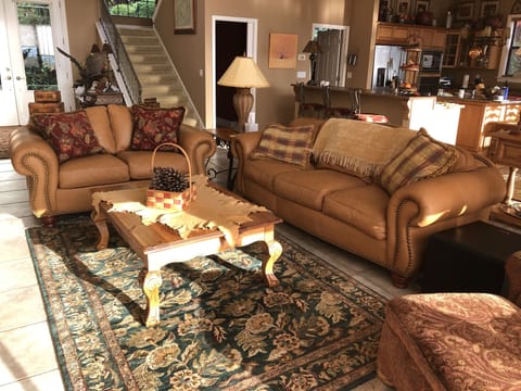 Great Room seating area with leather sofa & loveseat, and pine coffee table.