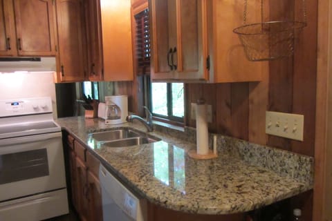 Full kitchen with granite countertops.