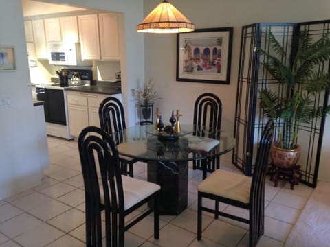 Dining area seats four next to the kitchen area.