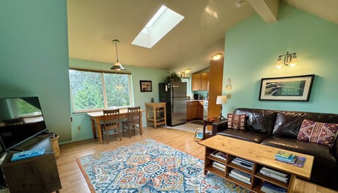 Living room with a glimpse of the dining area and kitchen