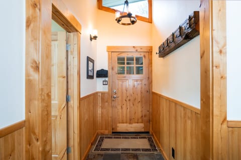 This entryway is designed with tiled floors for easy removal of jackets and shoes, keeping the rest of the home clean and organized