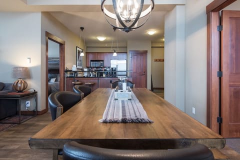 California hewn rough edge dining table with rustic chandelier