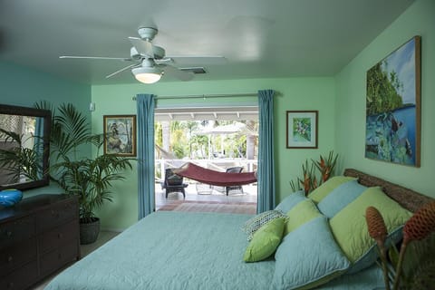 Master bedroom suite with french doors open.  Comfy hammock just outside.