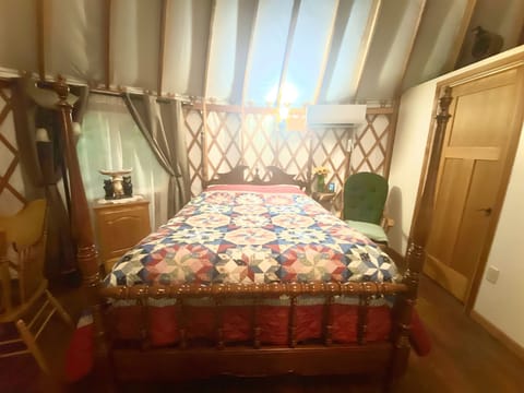 View of the bed near the bathroom 