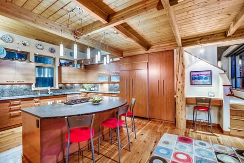 Spacious kitchen with warm cherry wood cabinets, granite countertops & views.