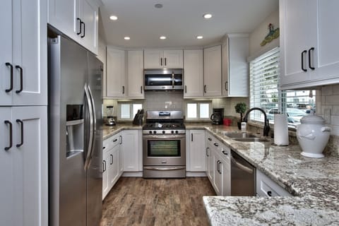 Bright Granite Kitchen with Stainless Steel Appliances