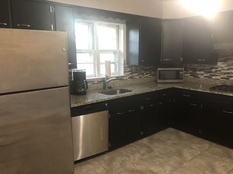 Granite counter top kitchen, with coffee maker and Samsung