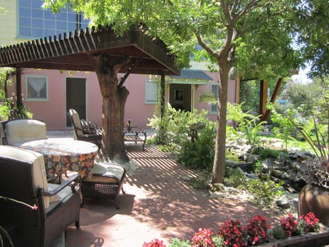View of patio with bedroom and living room doors open.