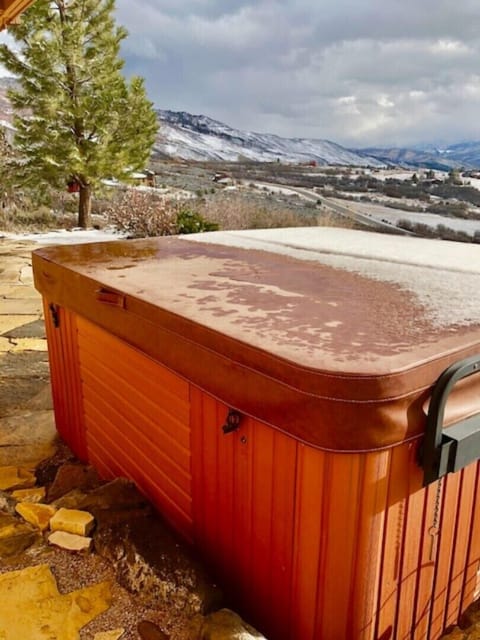 Outdoor hot tub with view of mountains, outside family room. Seats 6 people.