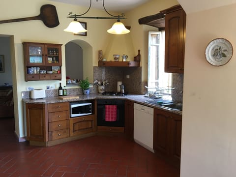 Between the Entry Room and the Living Room is the Kitchen.