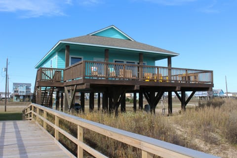 View of the front of the house that sits facing the beach from private walkover