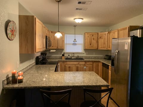Fully stocked kitchen with granite countertops. 
