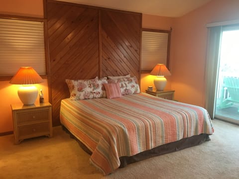 upper level master suite with king size bed and flat screen tv
