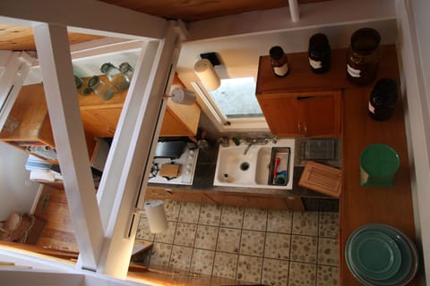 View from upstairs loft looking down into kitchen (small but stylish with lovely modern amenities!)
