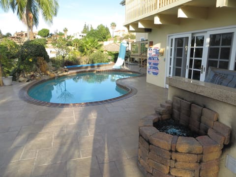 Beautiful Travertine Patio, pool, fountain, water slide, BBQ island & fire pit.