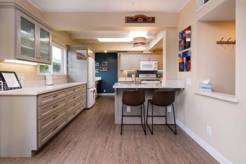 Kitchen area open to dining room features bar seating for 2