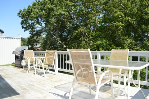 Back deck with gas grill and tables; seating for four