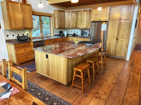 Large island is part of the kitchen space which creates a great mal prep space for any meal.