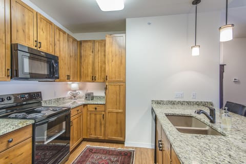 Kitchen - Full size appliances, including dishwasher, stove, above range microwave, and refrigerator.