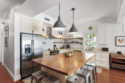 Kitchen includes large butcher block island with seating.