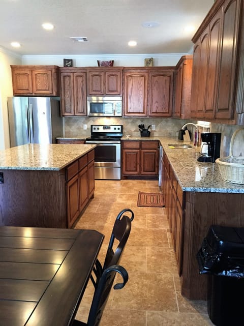 Beautiful Kitchen with Stainless Steel Appliances and Granite Counter Tops.