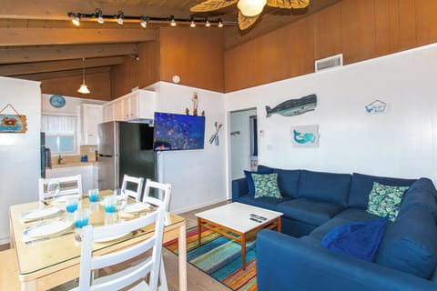 The dining table seats six, with a cozy bench on one side. Plus, there’s A/C and a peekaboo view of Newport Bay while you eat!