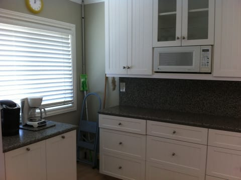 More of kitchen, coffee maker and cabinets.