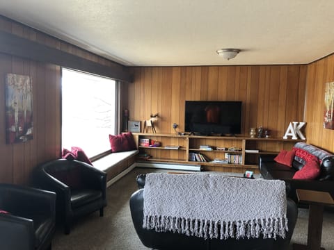 living room upstairs with fireplace at other end