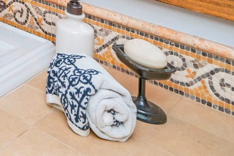 The bathroom is off a hallway that separates living and bedrooms. All with doors