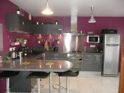 Kitchen opening on a large living room