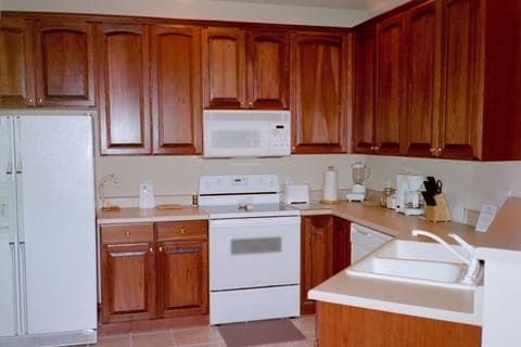 large kitchen with lots of cherry wood cabinets