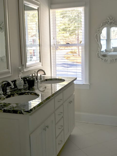 Dual sinks and glass-door shower in each upstairs bathroom. 